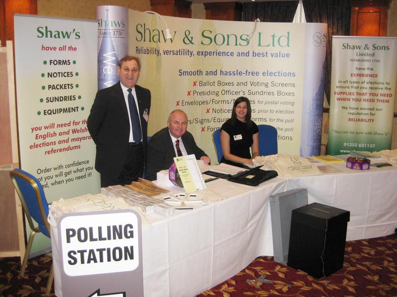 Shaw's stand at the AEA Annual Conference and Exhibition 2012. Pictured working at  the stand are some of Shaw's elections team: Dewi Williams (left), Philip Thompson (centre) and Sarah Bruty (right).